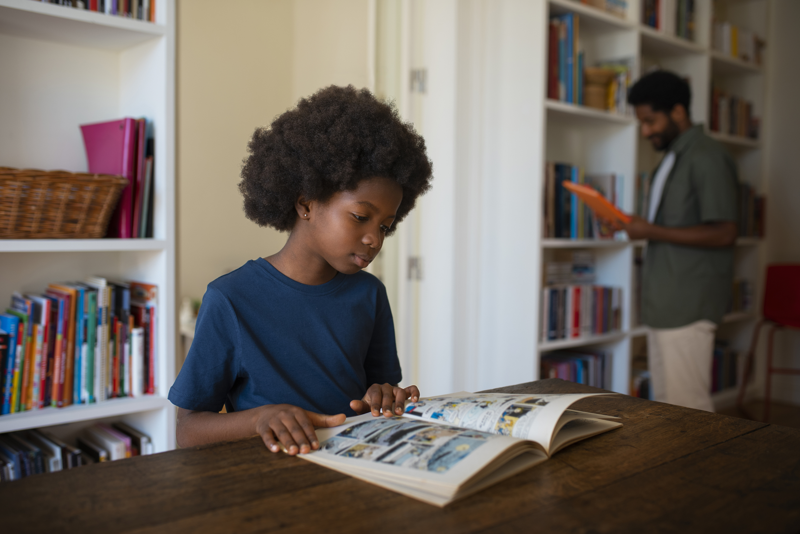 Home side view man boy reading comics home (1)